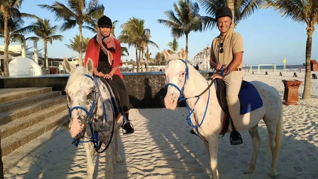 Two horse riders near the Hawana waterfront