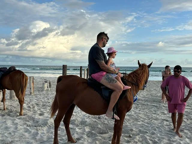 Child enjoying a horse ride on Salalah beach