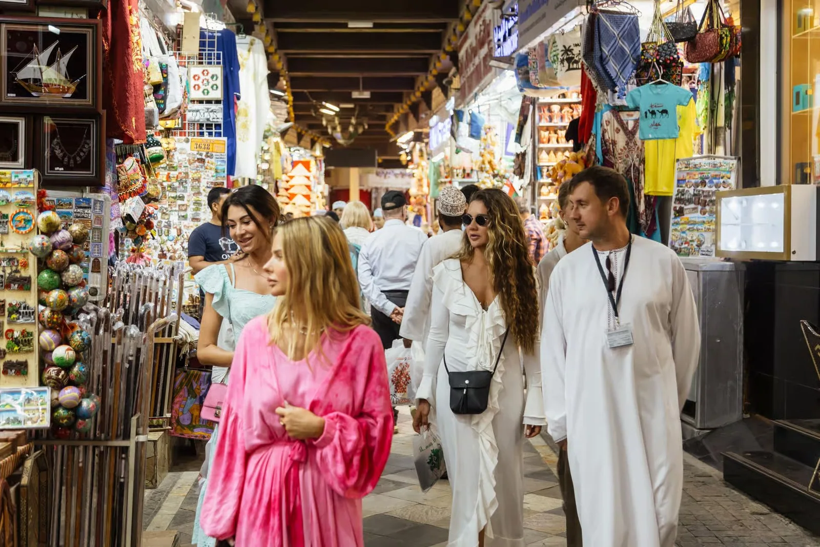 Visitors walking through market stalls