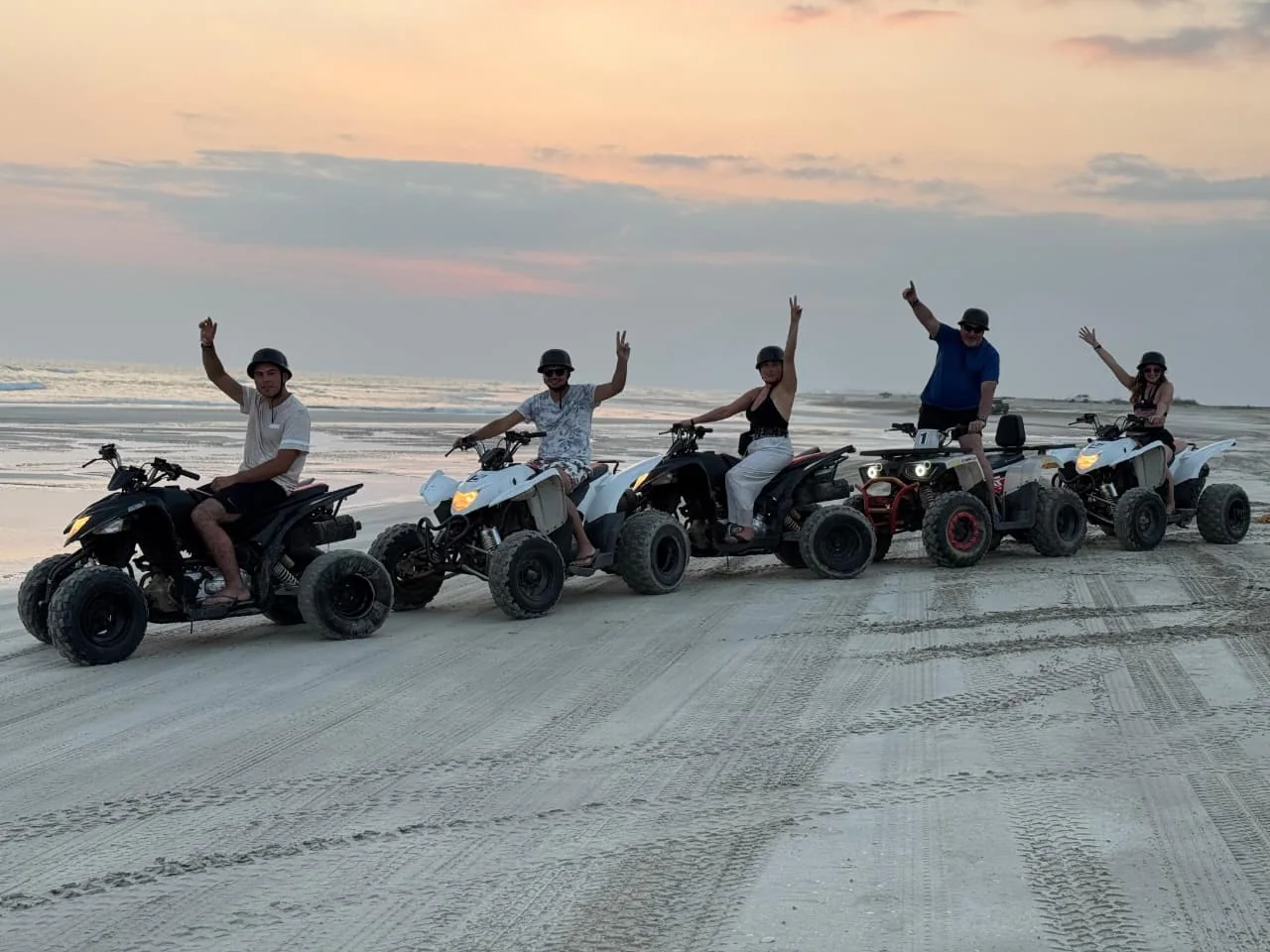 Riders and quad bikes on a sandy beach