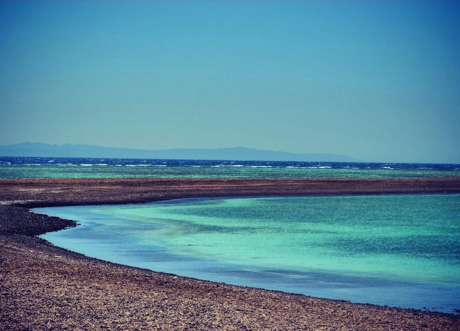Turquoise shallows and curved shoreline at Blue Lagoon near Dahab