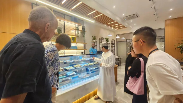 Visitors looking at food displayed in a shop