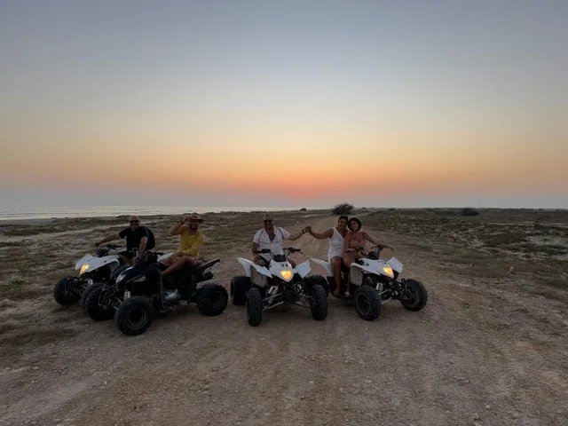 Rider on a quad bike in desert dunes