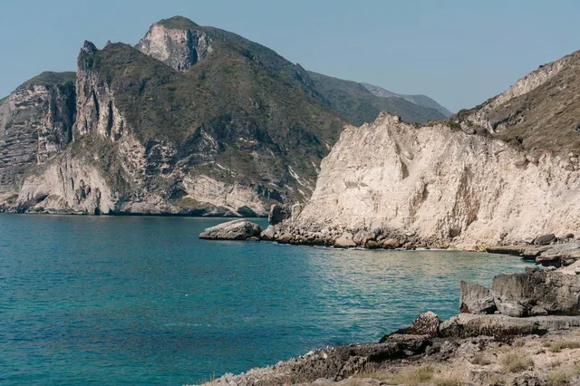 Rocky coastline and blue water west of Salalah